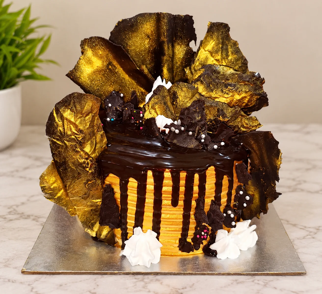 Luxury golden chocolate drip cake with handmade chocolate shards
